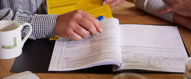 People looking at printed documents